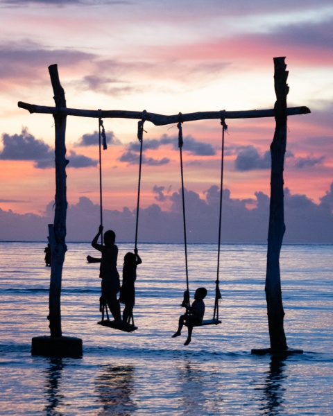 Bali, Indonesia - Things to Know & Tips for Visiting: Kids on a Swing at Sunset