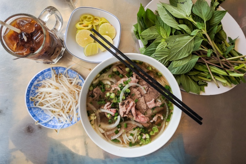 Herbs in Vietnam: Pho with a plate of Vietnamese Herbs